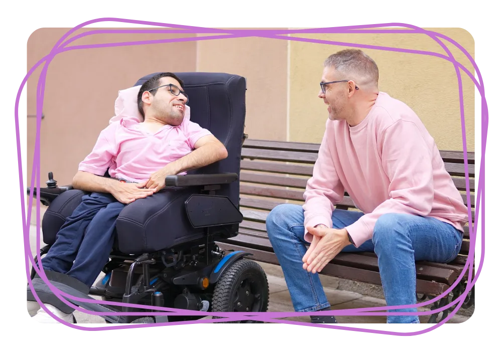 Disabled man smiling with support worker