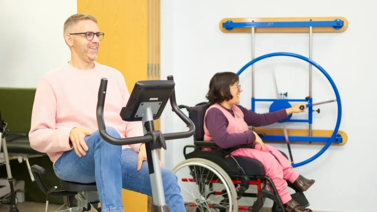 Support worker and disabled woman in exercise class